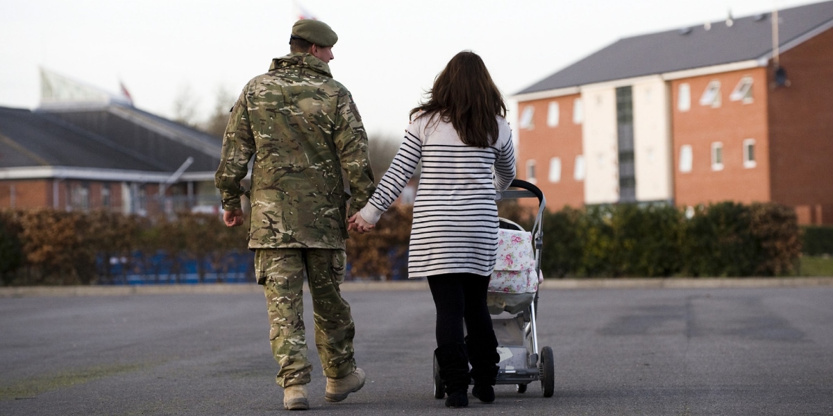 Soldier walking with partner and pram